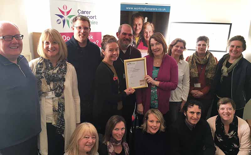 Pictured are some of the CSW team proudly showing their PQASSO certificate
