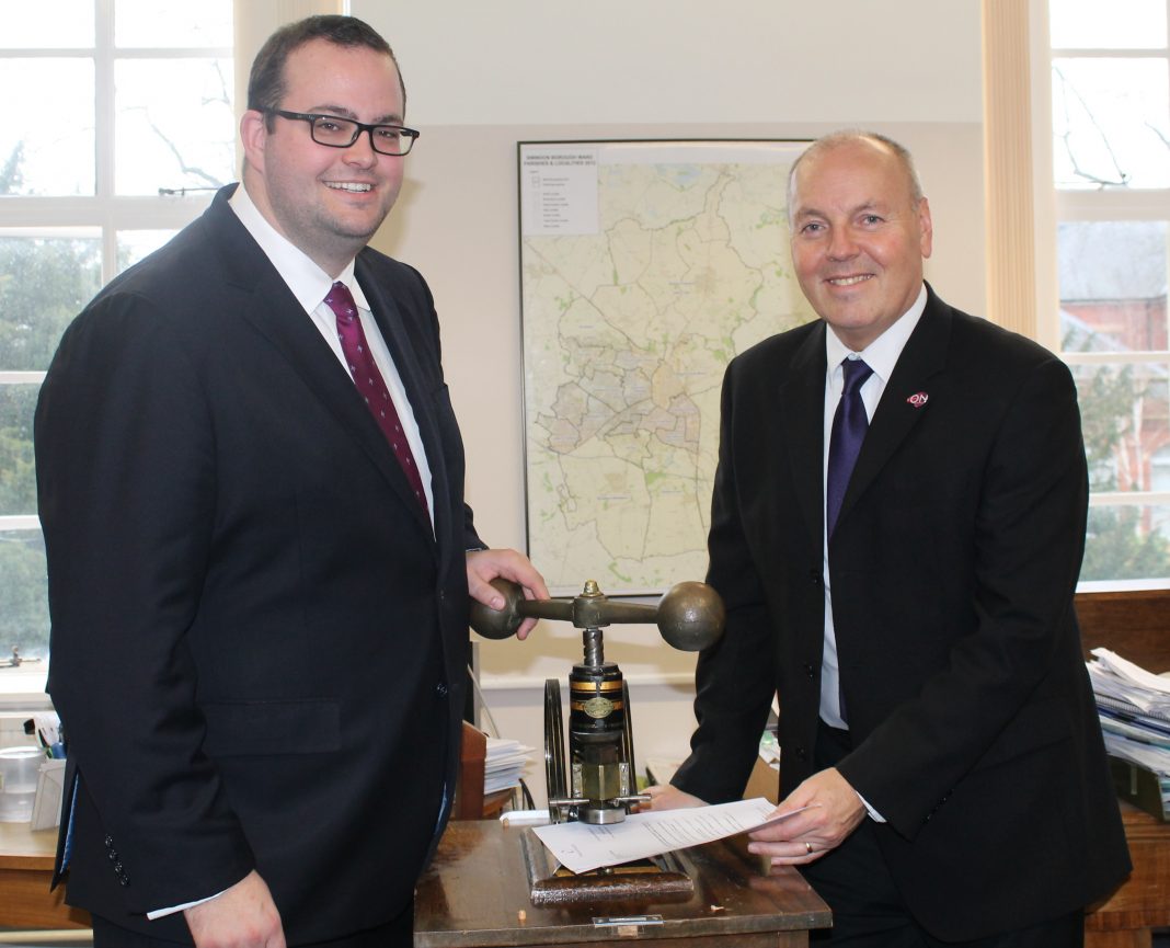 Cllr Toby Elliott, Swindon Borough Council’s Cabinet Member for Strategic Planning and Sustainability (left) with Swindon Borough Council’s Chief Executive John Gilbert using the Council’s embossing machine to affix the Council’s seal to the Wichelstowe Joint Venture documentation.