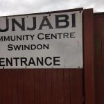 Graffiti written on sign at Punjabi Community Centre, Swindon