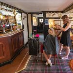 Hairdresser Vici Rogers and Lauren Owers in the Lord Eldon pub. Landlord Mark Gillick behind the bar.