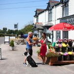 Janice Harding sells flowers to Trevor Mullineaux outside the Ye Old 3 pub.